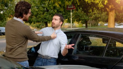 two-men-arguing-after-a-car-accident-on-the-road.jpg